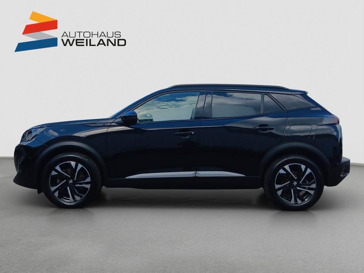 Auf diesem Bild ist ein dunkles SUV-Fahrzeug von der Seite zu sehen, präsentiert vor einem schlichten Hintergrund und mit dem Logo von Autohaus Weiland.